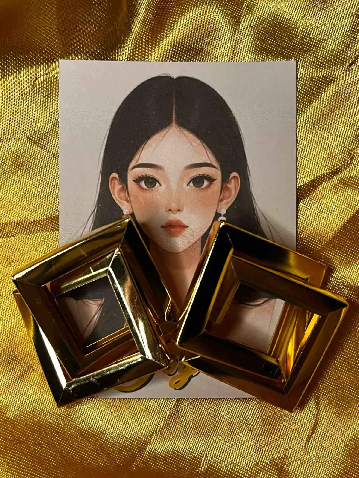 The Iconic 8 promotional portrait with featured square earrings on a gold fabric backdrop.